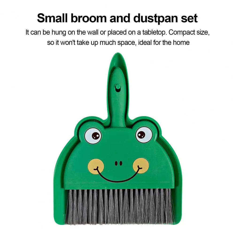 Green broom and dustpan set with a frog design on a white background