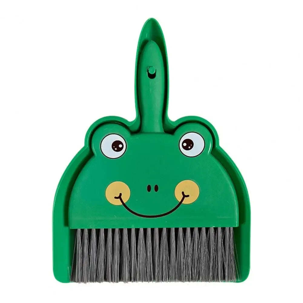 Green frog-shaped broom and dustpan set on a white background