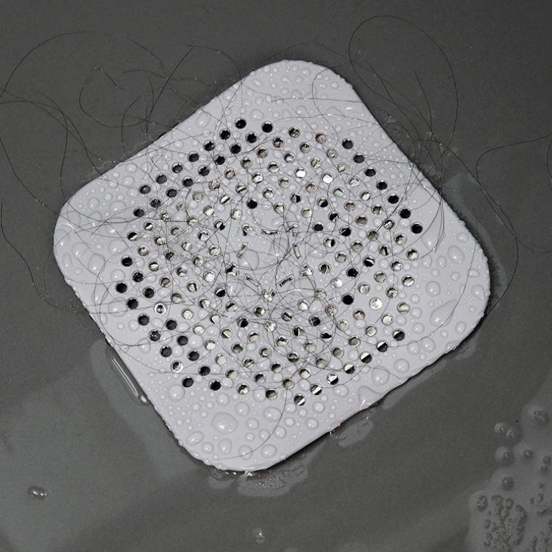 Silicone drain hair catcher shown trapping hair to prevent clogs