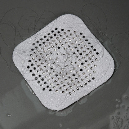 Silicone drain hair catcher shown trapping hair to prevent clogs