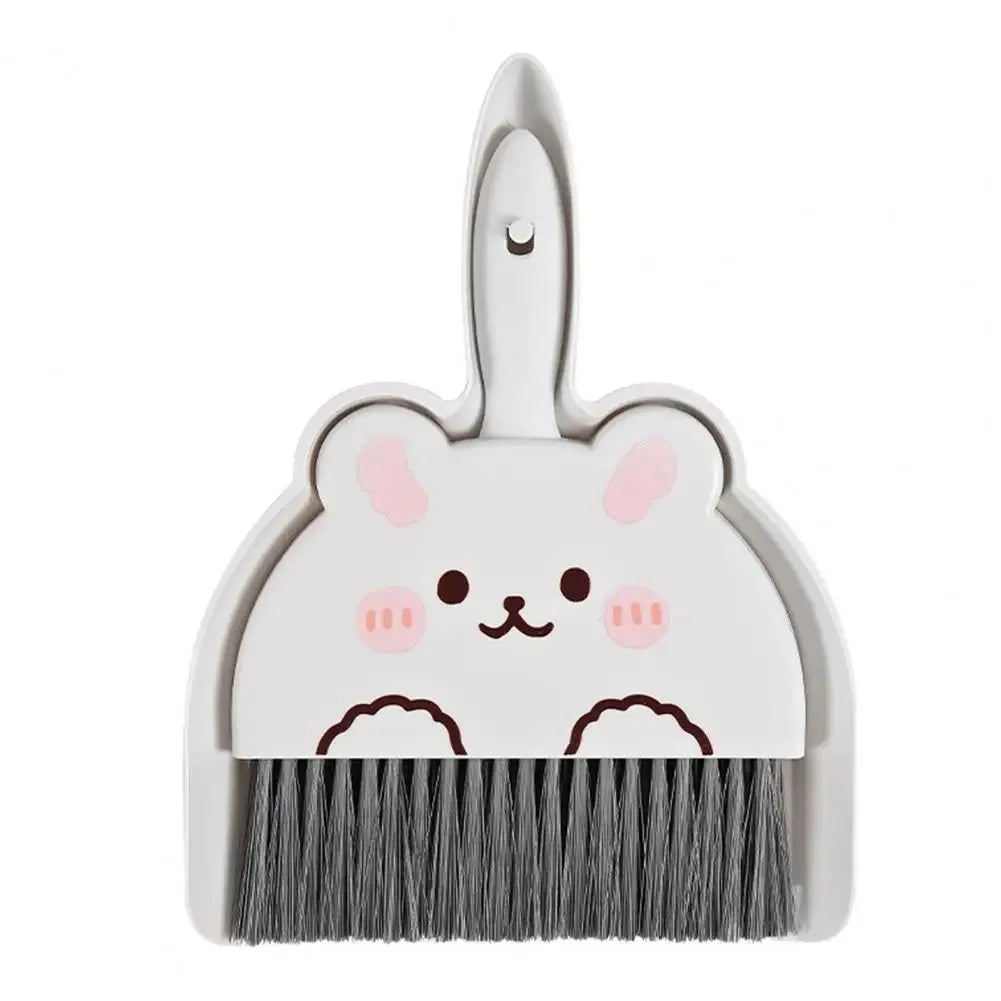 Green frog-shaped broom and dustpan set, front view on a white background