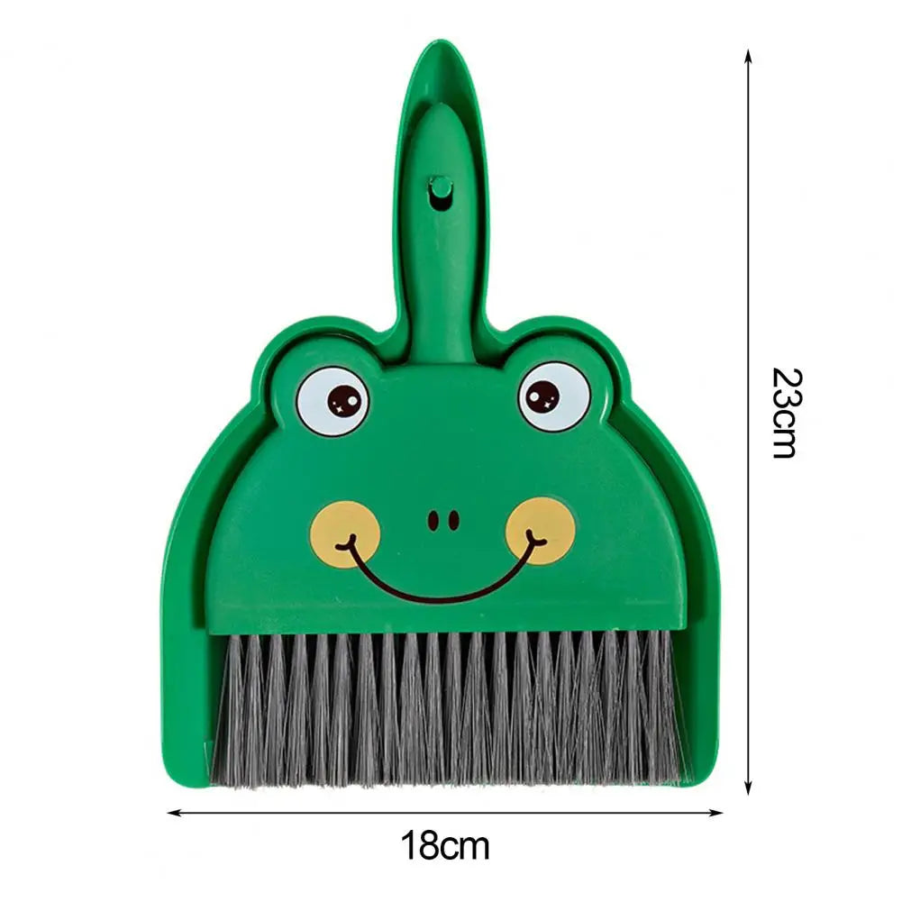 Green frog-shaped dustpan with brush attachment and measurements on a white background