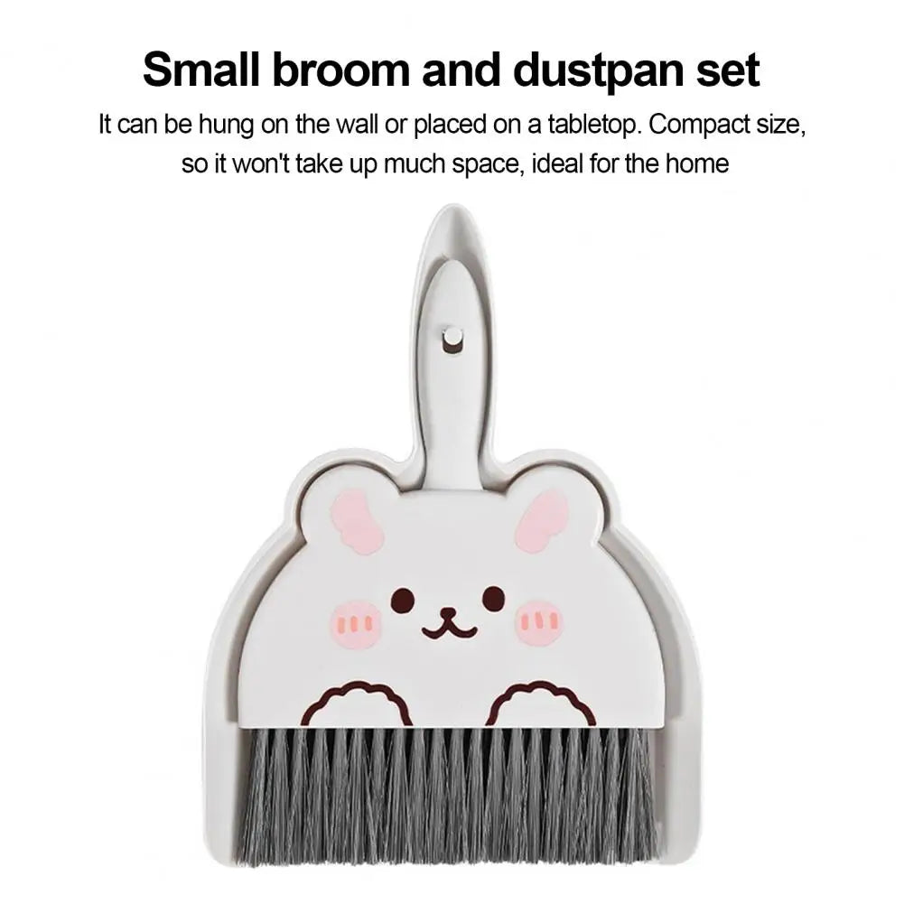 Small broom and dustpan set with a cute animal design on a white background