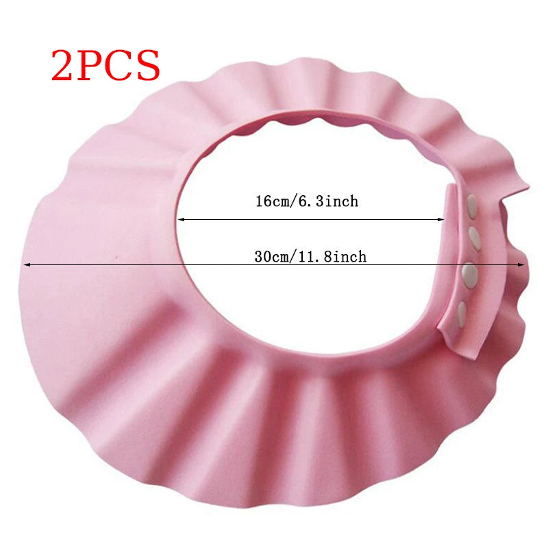 Pink silicone baby shower cap with scalloped edges and measurement markings showing 16cm/6.3inch and 30cm/11.