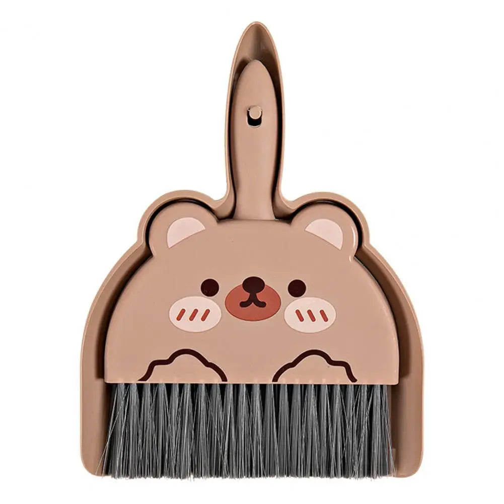 Cute bear-shaped dustpan and brush set on a white background